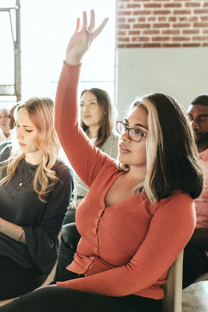 Cheerful woman speaking in a workshop