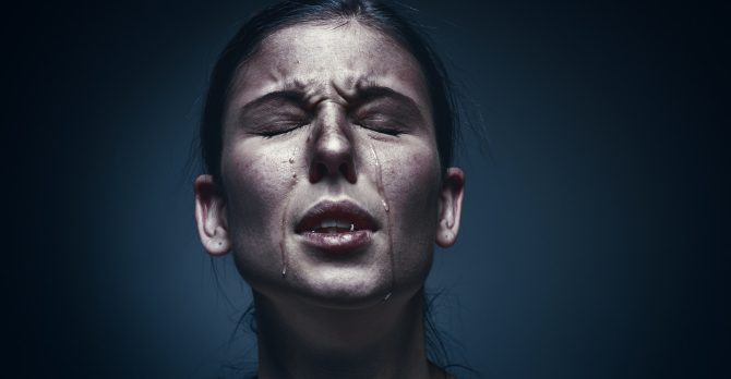 Close up portrait of a crying woman with bruised skin and black eyes