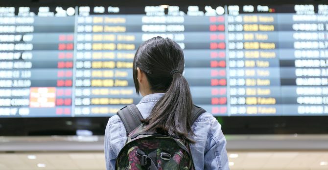 Travel woman holding passport in the airport